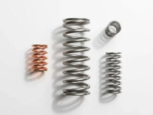 Precision-engineered coil spring standing vertically with three smaller springs arranged symmetrically on white surface, steel gray and copper tones